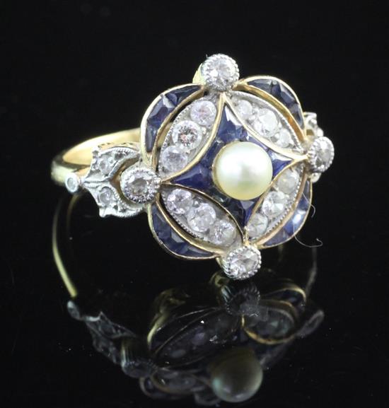 An Edwardian style gold, sapphire, diamond and seed pearl set cluster dress ring, size K.